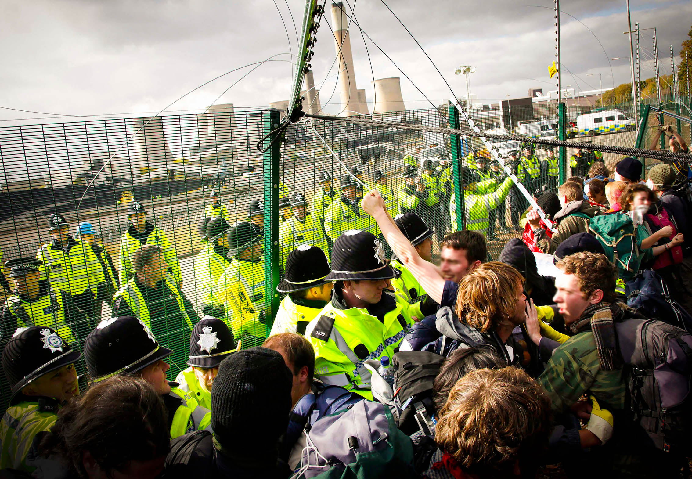 (photoshoot 1009-049) Police grapple with protestors attempting to gain access to Ratcliffe-on-Soar power station during a Camp for Climate Action rally today.  E.ON